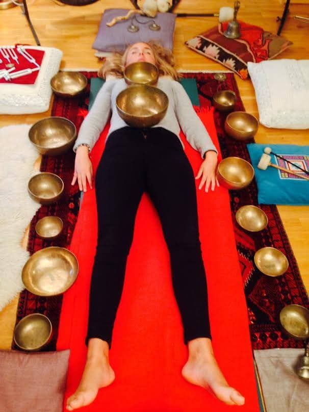 Person surrounded by singing bowls